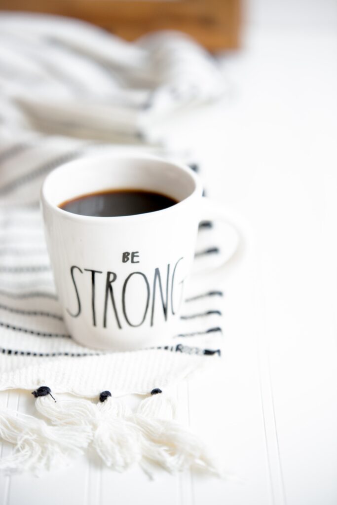 a coffee mug with Be Strong Print on it